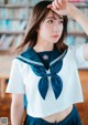 A woman in a sailor outfit posing for a picture.