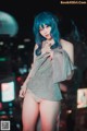 A woman with blue hair is posing for a picture.