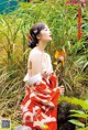 A woman in a red and white kimono holding a pinwheel.