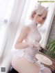 a woman in a white lingerie sitting on a bench